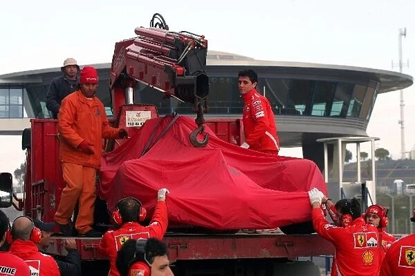 Formula One Testing: The Ferrari F2005 of Michael Schumacher is lifted from the recovery vehicle after a minor accident on his first flying lap