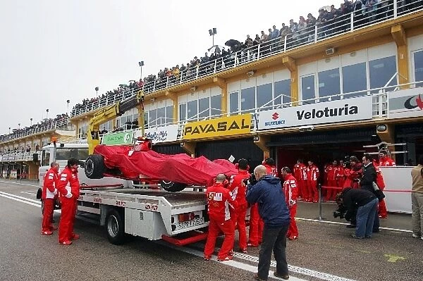 Formula One Testing: The Ferrari of Luca Badoer Ferrari Test Driver arrives back in the pits on the back of a truck