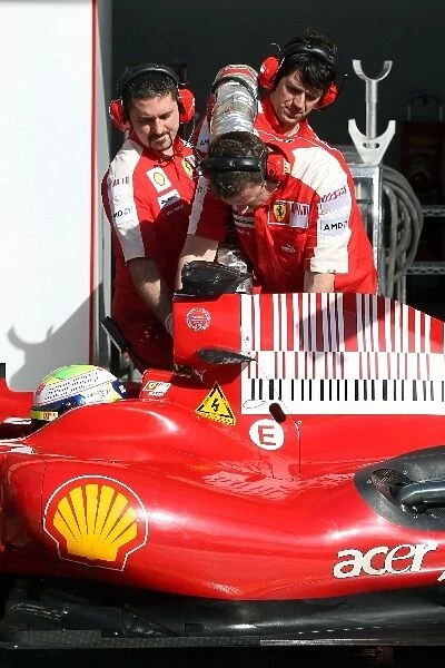 Formula One Testing: Ferrari mechanics with the refuelling hose