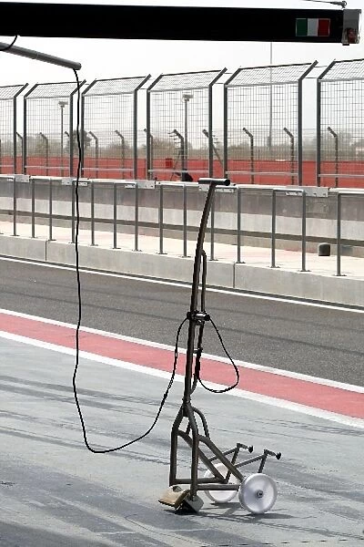 Formula One Testing: Ferrari rear jack attached to main pitstop structure via cable