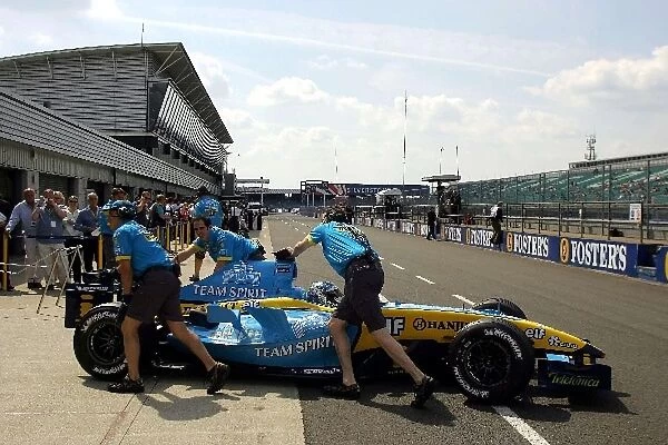 Formula One Testing: Jarno Trulli Renault R24 is pushed into the pits in front of the Renault guests