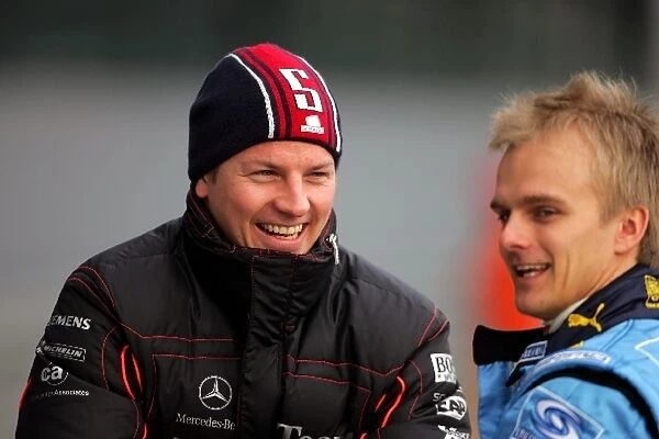 Formula One Testing: Kimi Raikkonen McLaren and Heikki Kovalainen Renault Test Driver talk in the pitlane