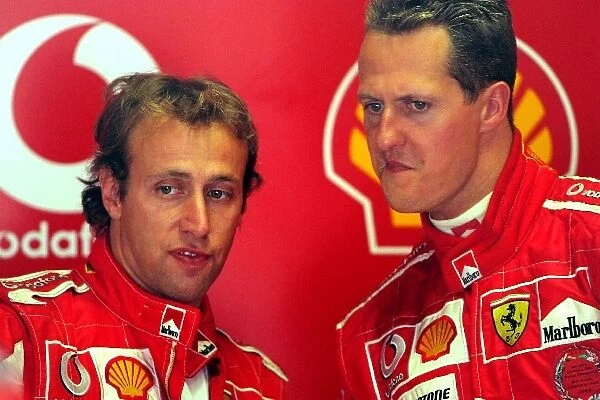 Formula One Testing: Luca Badoer Ferrari talks with Michael Schumacher Ferrari
