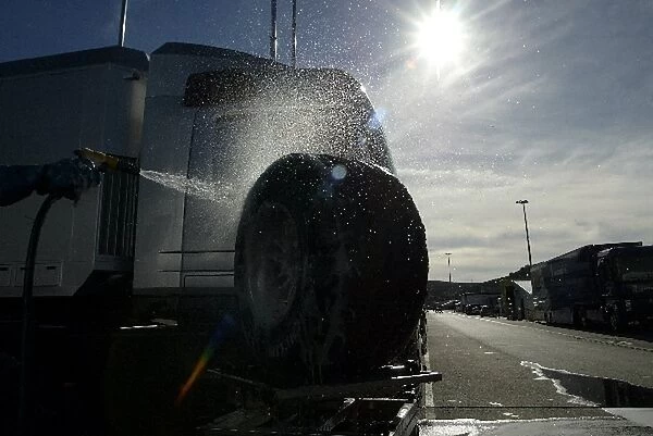 Formula One Testing: A McLaren mechanic washes the cars Michelin tyres