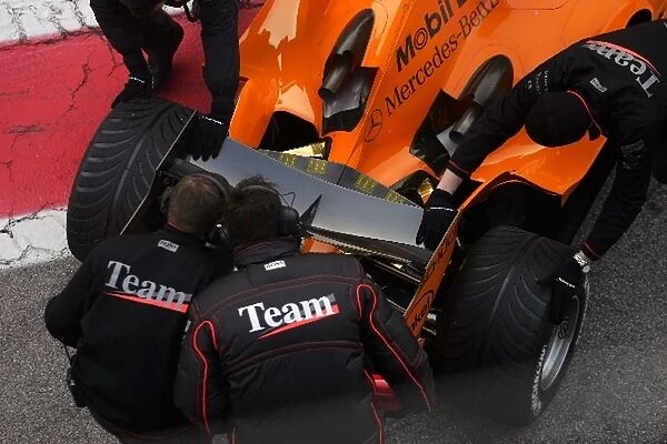 Formula One Testing: McLaren mechanics check the exhausts of Kimi Raikkonen McLaren Mercedes MP4  /  21