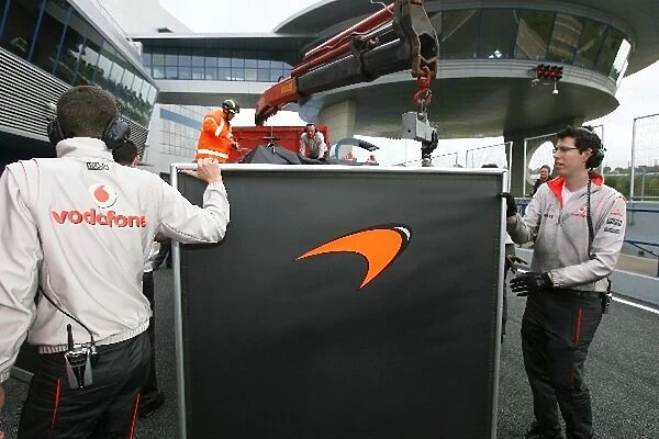 Formula One Testing: McLaren use screens to block their car from view after it returns from a stoppage on track