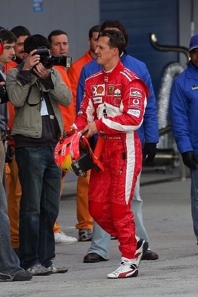 Formula One Testing: Michael Schumacher walks back to his pit garage after a minor accident on his first flying lap