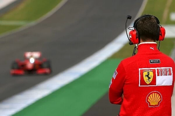 Formula One Testing: Michael Schumacher watches Felipe Massa Ferrari F60 trackside
