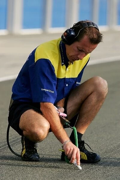 Formula One Testing: Michelin engineer checks the track tempature