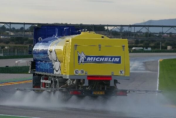 Formula One Testing: A Michelin transporter wets the circuit in preparation for tyre testing