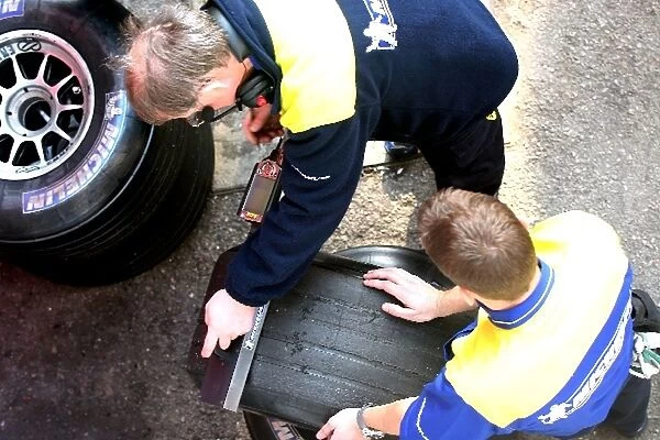 Formula One Testing: Michelin tyre engineers check a tyre