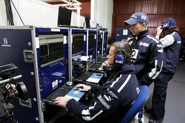 Formula One Testing: Nick Heidfeld Williams and engineers study telemetry from the Williams FW27 on the computers in the pits