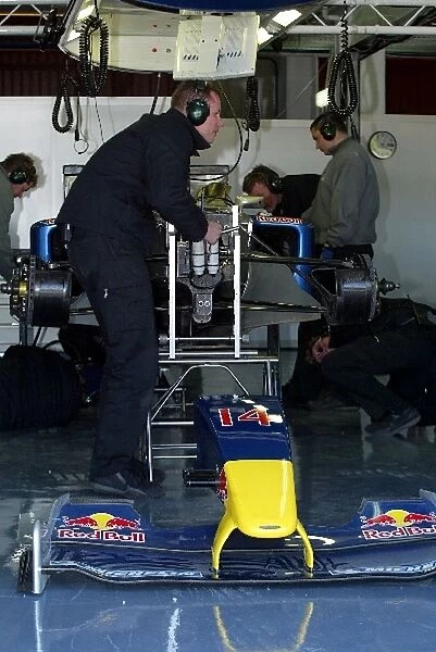 Formula One Testing: Red Bull mechanics work on the car of David Coulthard Red Bull Racing RB01