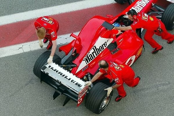 Formula One Testing: Rubens Barrichello Ferrari F2002 is pushed back into his pit garage