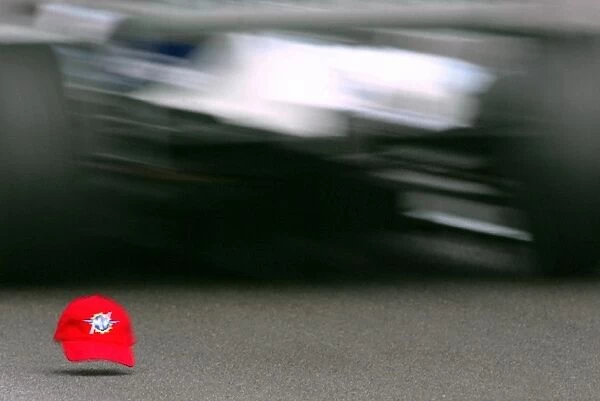 Formula One Testing: A spectators cap on the circuit is run over by Juan Pablo Montoya Williams BMW FW25