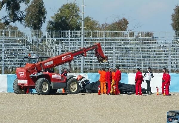 Formula One Testing: Takuma Sato BAR Honda 007 car is put onto the back of a truck, after crashing at turn 1