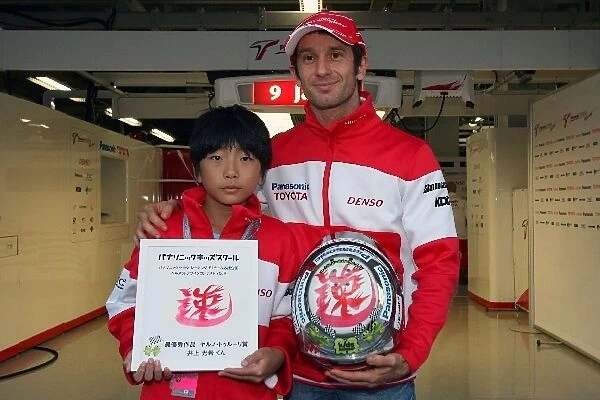 Formula One World Championship: 11-year old Mitsuki Inoue and the helmet he has designed for Jarno Trulli Toyota