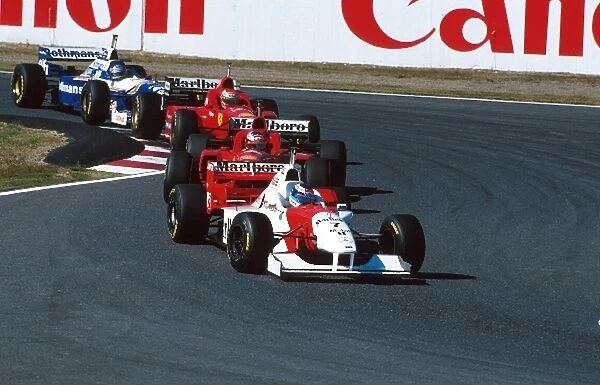 Formula One World Championship: 3rd placed Mika Hakkinen Mclaren MP4-11 leads Schumacher, Irvine and Villeneuve