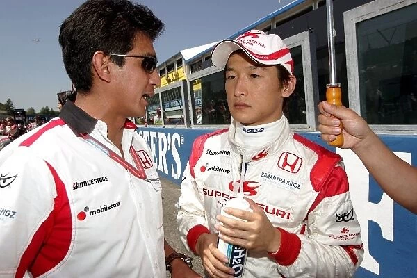 Formula One World Championship: Aguri Suzuki Super Aguri F1 Team Principal with Yuji Ide Super Aguri F1 Team on the grid