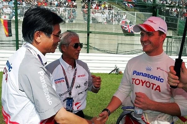 Formula One World Championship: Akihito Saito Executive Vice President Toyota Motor Corporation with Ralf Schumacher Toyota on the grid