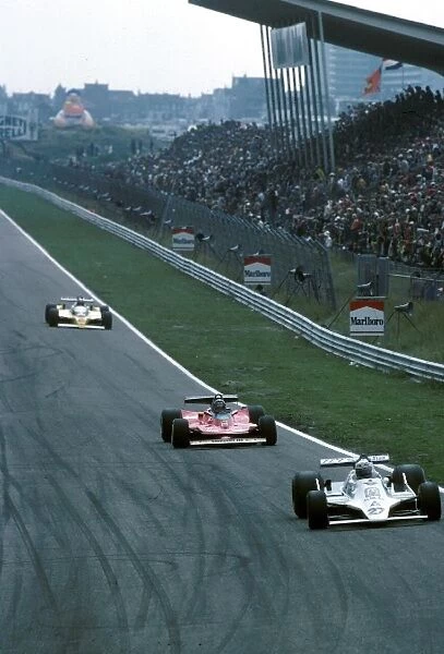 Formula One World Championship: Alan Jones Williams FW07 leads Gilles Villeneuve Ferrari 312T4 and Jean Pierre Jabouille Renault RS10