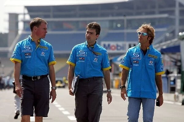 Formula One World Championship: Alan Permane Renault Race Engineer, Nick Chester Renault and Jarno Trulli Renault walk the circuit