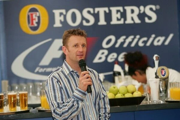 Formula One World Championship: Allan McNish talks in the Fosters hospitality area