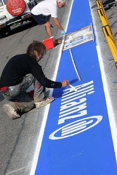 Formula One World Championship: Allianz branding is painted in the pitlane