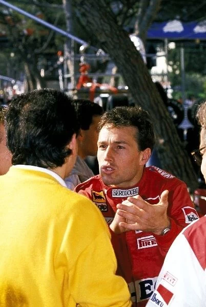 Formula One World Championship: Andrea de Cesaris Dallara, who finished the race in thirteenth position, has an animated conversation in the pit area