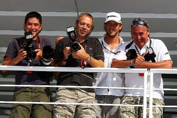 Formula One World Championship: Andrew Ferraro Photographer with Mark Thompson Photographer; Jenson Button Brawn Grand Prix and Mark Sutton