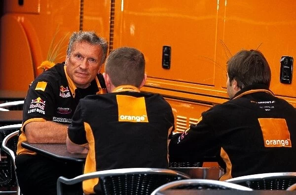 Formula One World Championship: Arrows boss Tom Walkinshaw talks to Heinz-Harald Frentzen, right and engineer