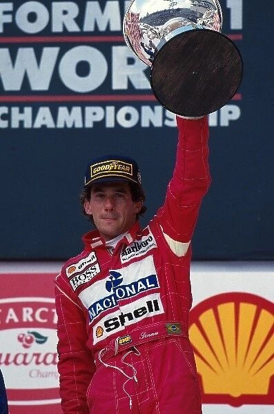Formula One World Championship: Ayrton Senna celebrates his win on the podium