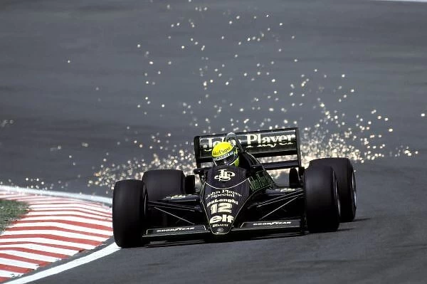 Formula One World Championship: Ayrton Senna Lotus 98T, who finished the race in second position, sends the sparks flying as he climbs Eau Rouge