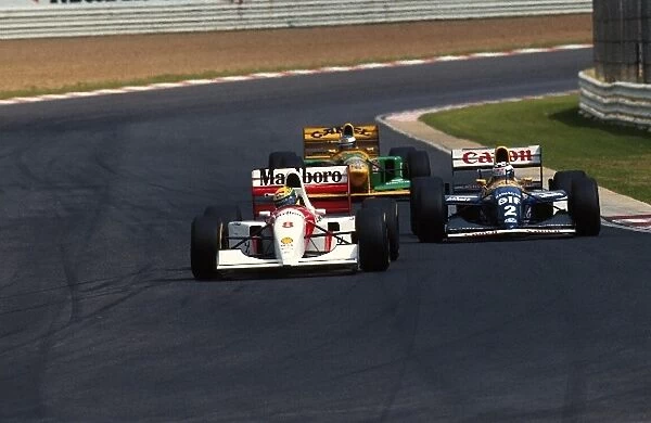 Formula One World Championship: Ayrton Senna McLaren MP4  /  8 leads race winner Alain Prost Williams FW15C and Michael Schumacher Benetton B192B