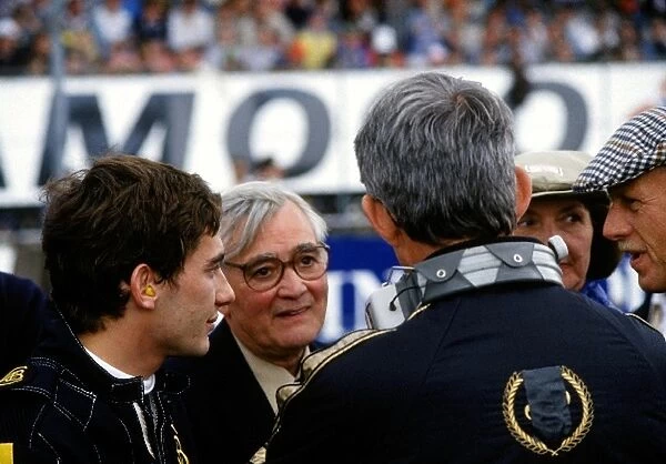 Formula One World Championship: Ayrton Senna talks with Lotus team members and guests to the race