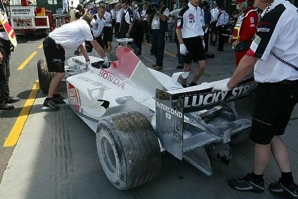Formula One World Championship: The BAR 005 of Jacques Villeneuve is returned to the pits following a fire on track during practice