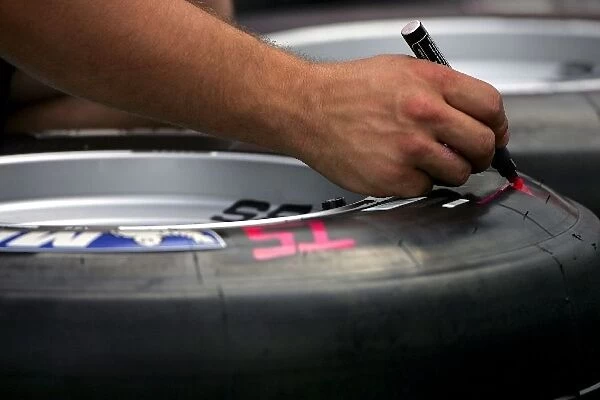Formula One World Championship: A BAR mechanic marks tyres for Takuma Sato BAR