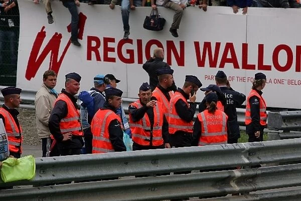 Formula One World Championship: Belgian police watch as fans invade the track
