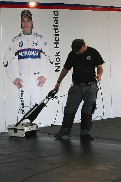 Formula One World Championship: A BMW Sauber F1 worker cleans the floor of the Sauber pit lane park