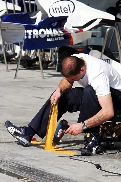 Formula One World Championship: BMW Sauber mechanic removes some taping in the pits