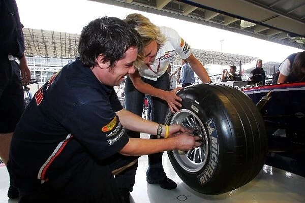Formula One World Championship: Britta Roeske Practices a wheel change