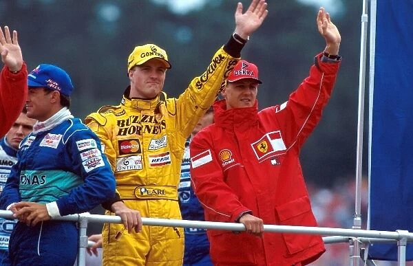 Formula One World Championship: Brothers Michael Schumacher, Ferrari F300, 5th place and Ralf Schumacher, Jordan 198 6th place wave to their fans