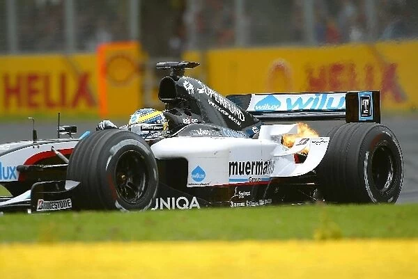 Formula One World Championship: The car of Gianmaria Bruni Minardi Cosworth PS04B spits flames out of the exhaust
