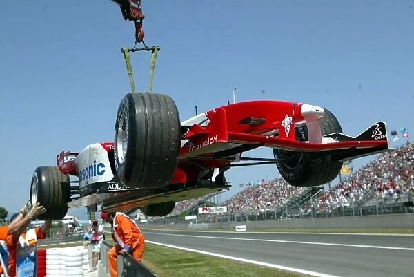Formula One World Championship: The car of Olivier Panis Toyota TF103 is craned away