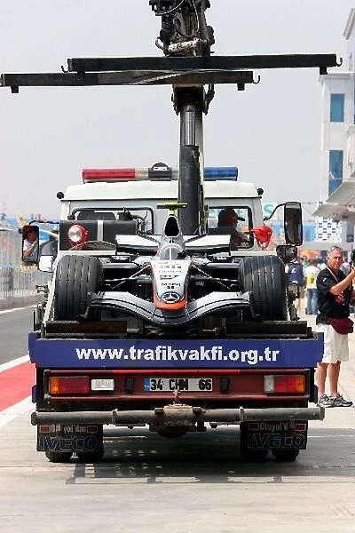 Formula One World Championship: The car of Pedro de la Rosa McLaren Mercedes MP4  /  20 is returned to the pits on a truck after stopping on track