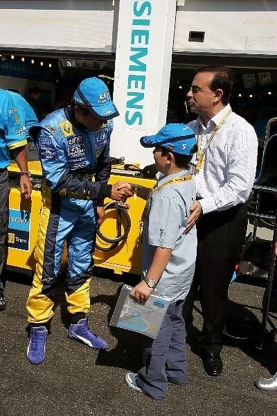 Formula One World Championship: Carlos Ghosn Chairman of Renault with his son and Giancarlo Fisichella Renault