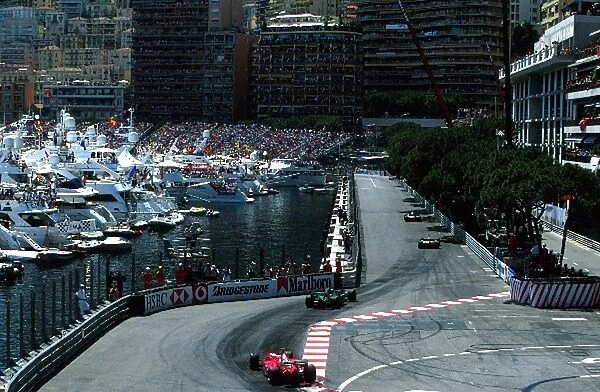 Formula One World Championship: The cars pass through the chicane and head alongside the harbour of Monaco