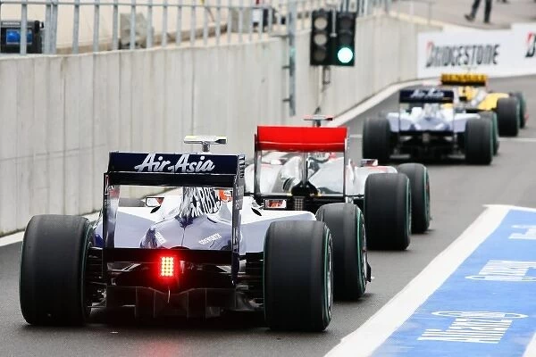 Formula One World Championship: Cars queue to restart the Second Practice Session