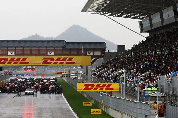 Formula One World Championship: Cars wait on the grid after the Red Flag