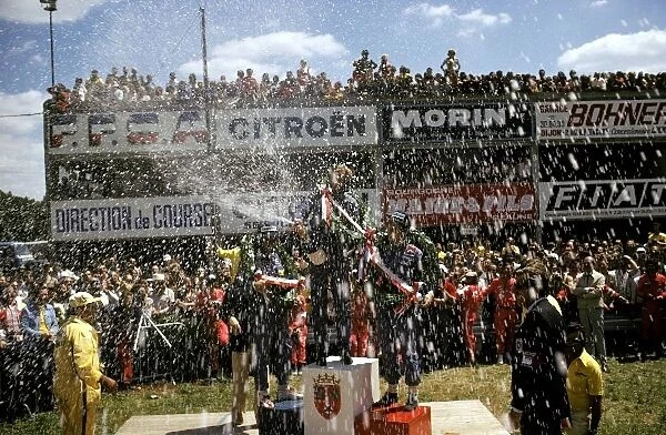Formula One World Championship: A champagne celebration on the podium: Clay Regazzoni Ferrari third; Ronnie Peterson Lotus winner; Niki Lauda